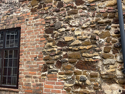 Victorian-style brick and stone wall showing weathered texture and historical character, relevant to old house restoration and sash window repair discussions.