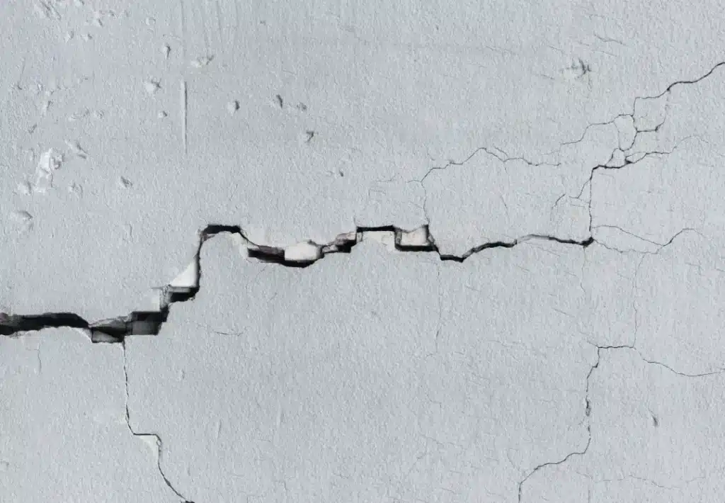 Cracks in a wall indicating structural issues, highlighting the importance of monitoring for restoration in historic buildings.