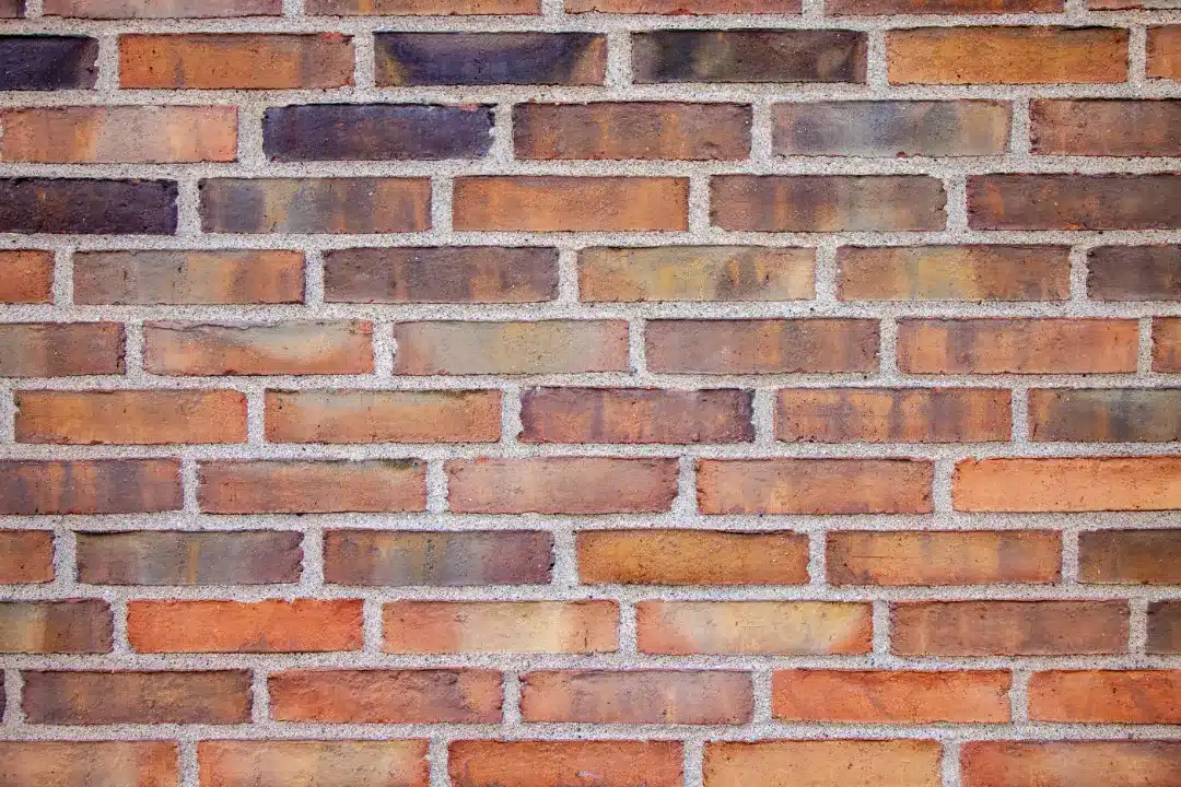 Brick wall texture showcasing various shades and patterns, relevant to DIY and professional brick cleaning discussions.