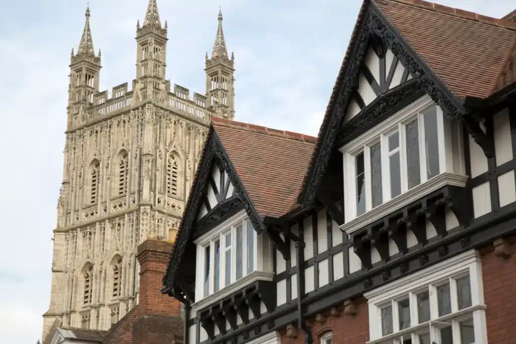 Historic building with ornate architectural details and a tall, gothic-style tower in the background, representing heritage preservation and restoration principles.